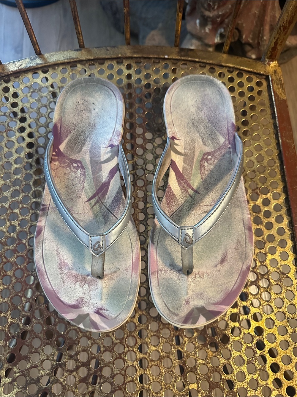 OluKai Metallic Silver Flip Flops with Purple Floral Accent